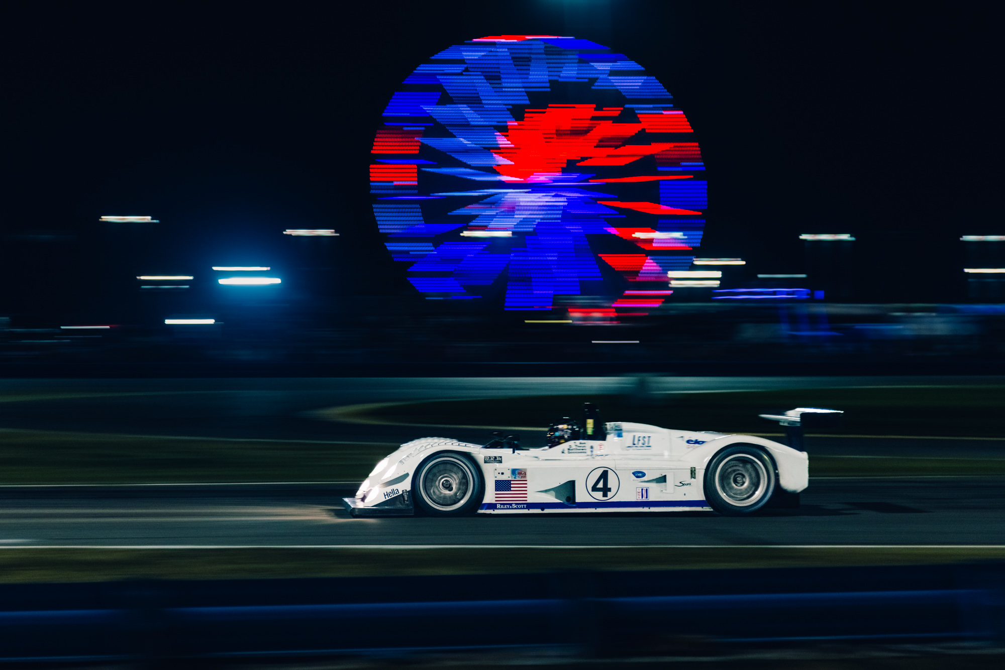 Riley & Scott Mk IIIC-004 historic event appearance IMSA Classic night qualifying race passing the ferris wheel